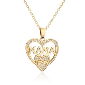 Detail of 18K gold heart pendant necklace featuring zircon MAMA engraving and crystals