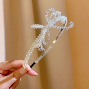 Detail of French vintage headband with double bow made of faux pearls and crystals
