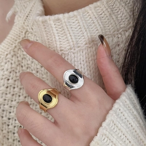 925 silver vintage rings with black agate stones worn on hand over cozy knitwear