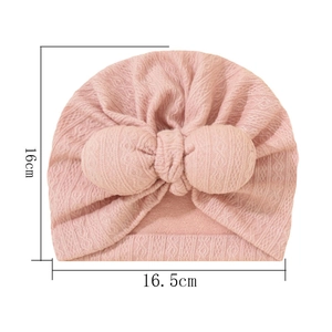 Pink infant turban hat with bunny ears and dimensions 16cm by 16.5cm on white background