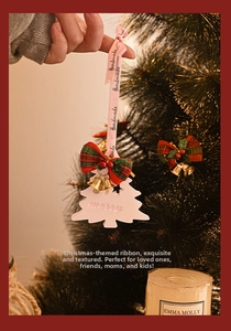 Close-up of handmade Christmas tree aromatherapy plaster ornament with a festive bow and bell