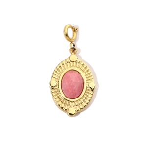 Detail of vintage gold pendant with oval pink gemstone and sunburst texture