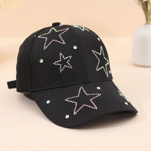Detailed view of rainbow rhinestones star patterns on black cotton baseball cap fabric