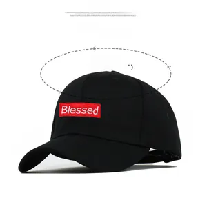 Detail of black baseball cap showing Blessed embroidery and size specifications