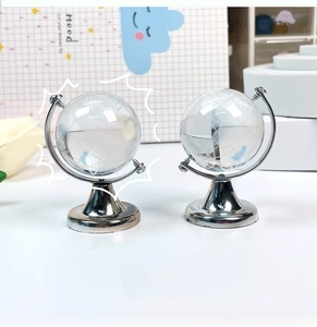 Detail of creative mini crystal globe ornaments with silver metal base for desk decoration
