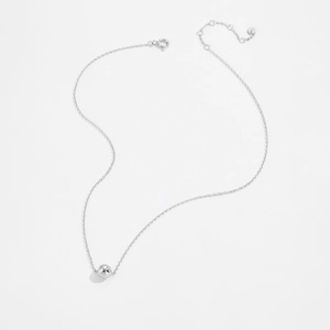 Detailed view of a minimalist 925 sterling silver ball pendant necklace on white background
