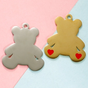 Detailed view of bear-shaped pendants in silver and gold with tiny red hearts