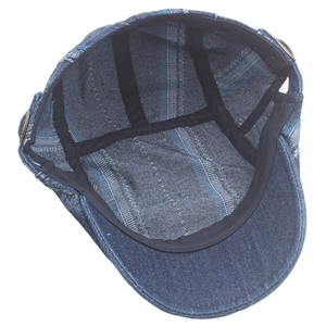 Detail view of denim beret cap interior with blue striped lining and sweatband stitching