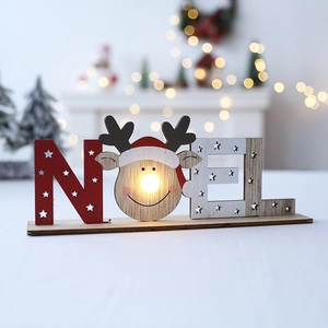 Illuminated wooden Christmas NOEL sign with LED deer head on festive tree background