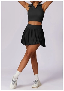 Detail view of a black Polo style sleeveless crop top and high-waisted pleated tennis skirt