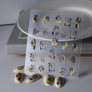 Macro shot of 5D embossed bamboo nail art stickers with gold ink and 3D relief texture