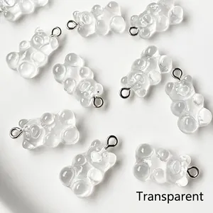 Close-up of transparent resin gummy bear charms with silver metal loops for DIY jewelry