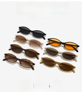 Flat lay of retro oval sunglasses in multiple colors showing frame textures and lenses