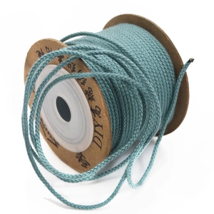 Close-up of 1.5mm blue cotton weaving cord on a spool for DIY jewelry and crafts