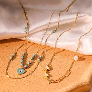 Bohemian gold-plated necklace with evil eye heart charm and layered turquoise beads