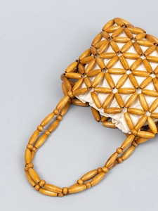 Handmade wooden bead handbag with geometric weave and ivory drawstring inner lining