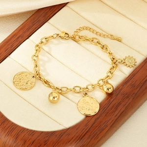Gold stainless steel sun and moon charm bracelet with metal beads in a jewelry box