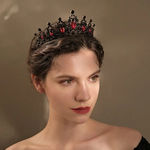 Close-up of vintage black gold crown with red teardrop rhinestones for bridal hair
