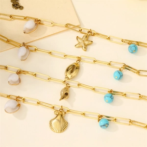 Gold stainless steel bracelet set with natural shells and ocean charms for beach vacation