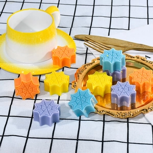 Halloween spider web shaped scented candles in bright orange yellow blue and purple colors