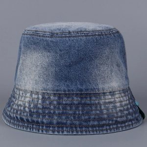 Close-up of gradient washed denim bucket hat with reinforced stitching and vintage texture