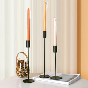 Set of three black matte metal candle holders in Nordic style for dining table decor
