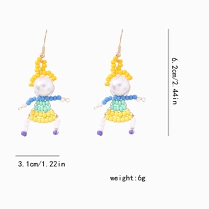 Detailed view of handmade beaded doll earrings with pearls and dimensions marked