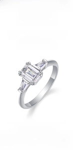 Macro view of three emerald-cut moissanite stones on a 925 sterling silver ring
