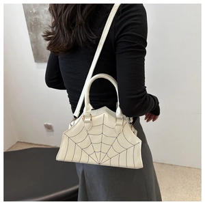 Professional model showcasing white bat-shaped shoulder bag with spider web patterns on back