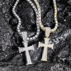 Hip hop style gold and silver cross necklaces with sparkling rhinestones on rock background