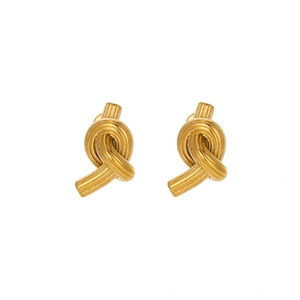 Detail showing high-quality brushed texture on golden knot-shaped stainless steel earrings
