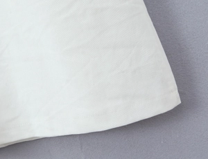 Detail of the white nautical dress showing high-quality double stitching on flat fabric