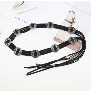 Close-up of bohemian black suede waist chain with silver discs and long tassels