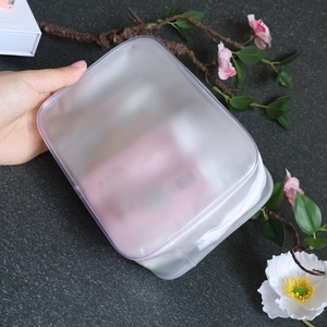 Handheld frosted semi-transparent waterproof PVC toiletry bag with white zipper closure