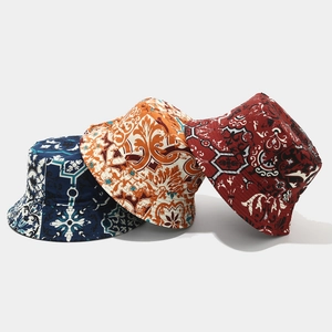 Detailed view of printed bucket hats in navy, yellow and red vintage patterns