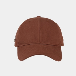 Detailed close-up of dark brown cotton baseball cap with vintage woven side label detail