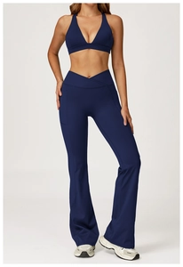 Detail of navy blue crossover yoga set with V-neck sports bra and flared leggings