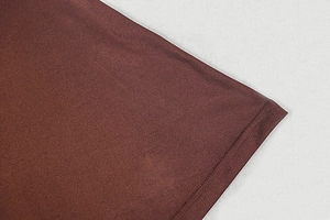 Macro detail of dark brown knit fabric showing precision double-needle hem stitching