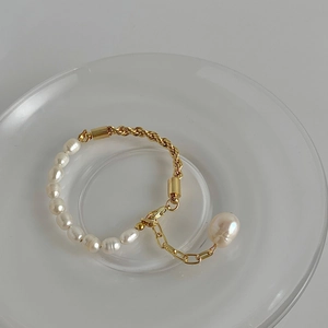 Detail of baroque pearl necklace with gold-plated chain and large pearl pendant charm