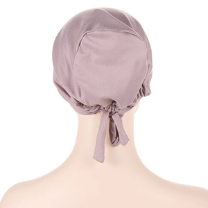 Rear view of dusty pink satin lined turban cap with elastic band and ribbon bow tie
