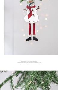 Macro detail of wooden long-legged snowman ornament hanging on a Christmas tree