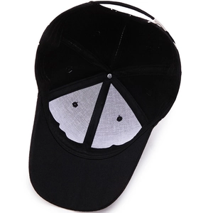 Black graffiti baseball cap interior showing white lining and adjustable metal buckle strap