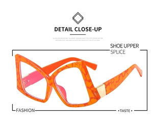 Close-up of orange butterfly glasses frame with leopard patterns and gold metal details