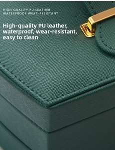 Macro shot of dark green cross-grain PU leather jewelry box with gold metal lock