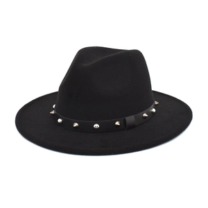 Close-up of black wool fedora featuring leather band with gold rivets and studs