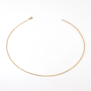 Detail of 18K gold box chain with lobster clasp and adjustable extension on white background