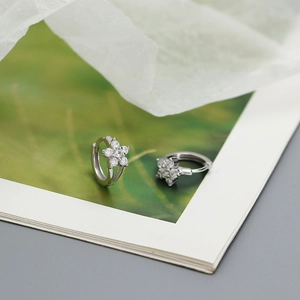 Close-up of S925 sterling silver flower hoop earrings with sparkling cubic zirconia
