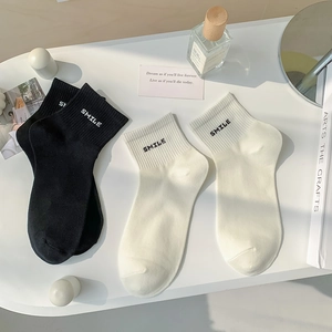 Detailed view of Smile embroidery on cotton crew socks in black and white styles