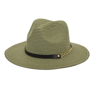 Close-up of wide brim straw sun hat with black leather strap and gold chain detail