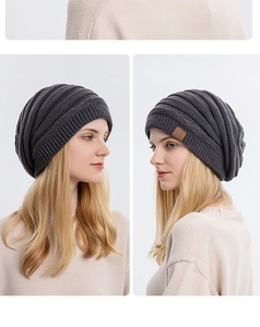 Close-up of dark grey knitted beanie with thick ribbed texture and brown leather patch